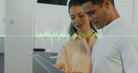 Colleagues Reviewing Data Report with Augmented Waveform Visualization in Modern Office