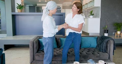 Senior Friends Laughing Embracing in Cozy Living Room Joyful Connection
