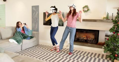 Women enjoying virtual reality indoor dance party during holidays