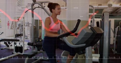 Young woman exercising on elliptical with red fitness data overlay, cardio workout technology
