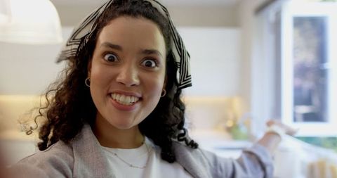 Cheerful Woman in Modern Kitchen with Welcoming Atmosphere