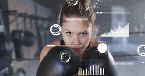 Female boxer training with futuristic hud fitness data, intense focus and boxing gloves