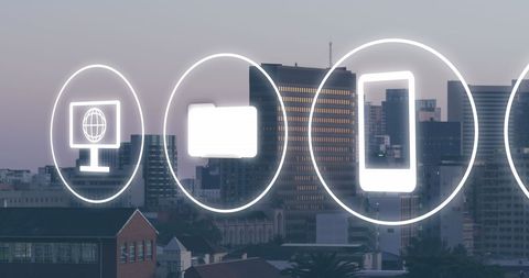 Media and Business Icons Over Cityscape at Dusk
