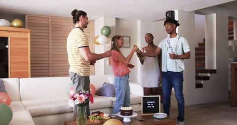 Friends Toasting Success in Joyful Celebration for New Job at Home