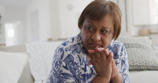 Pensive Mature Woman Sitting on Sofa in Cozy Living Room - Download Free Stock Images Pikwizard.com