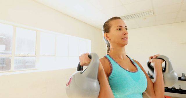 Fit Woman Lifting Kettlebells in Gym - Download Free Stock Images Pikwizard.com