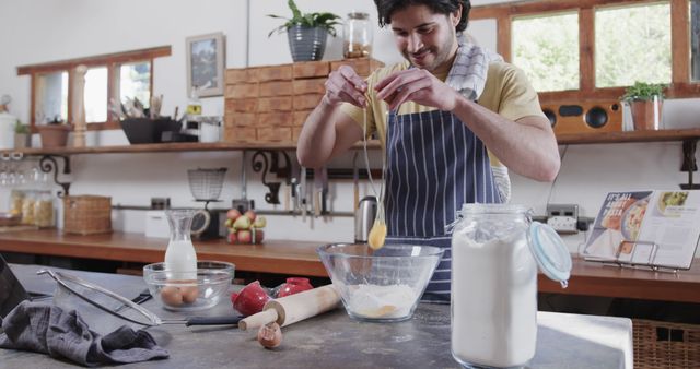 Smiling Man Wearing Apron Cracking Egg into Mixing Bowl in Bright Home Kitchen - Download Free Stock Images Pikwizard.com