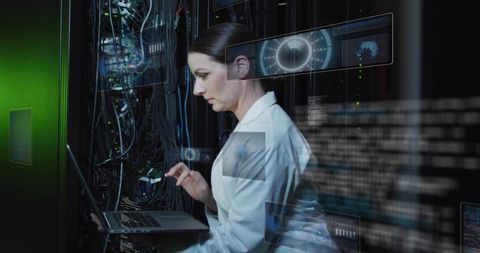 Woman IT technician configuring server rack with laptop and holographic data overlays