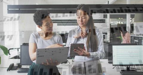 Professionals using technology in modern office for data analysis