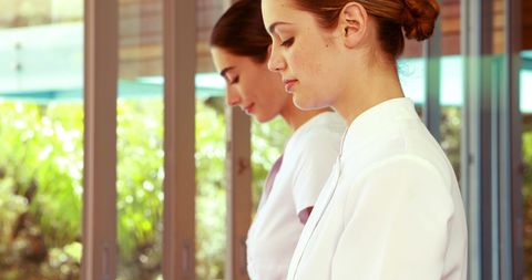 Two Female Therapists Working in Spa with Natural Light Ambience