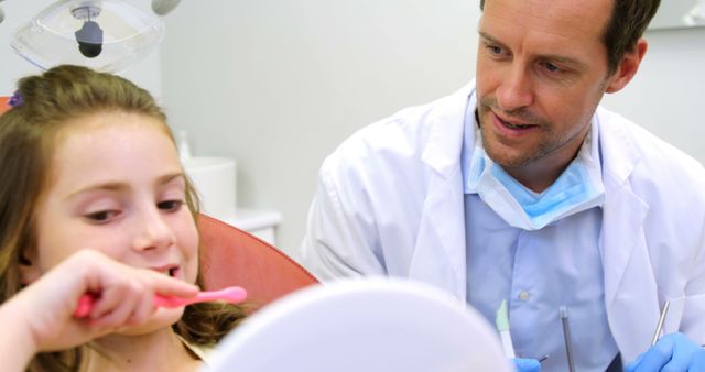 Female Child Learning Teeth Brushing Technique from Male Dentist - Download Free Stock Images Pikwizard.com