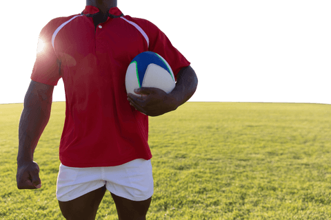 Transparent athlete holding rugby ball in sunlit stadium