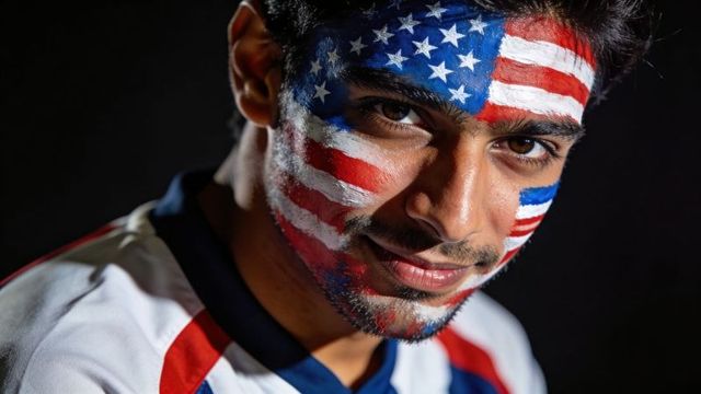 Closeup male fan wearing american flag face paint staring confidently, star-spangled portrait
