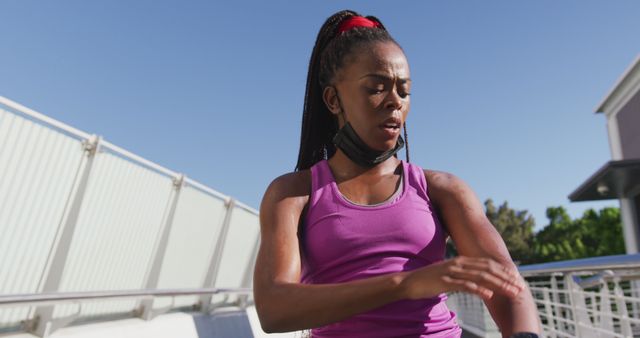 Female Athlete Adjusting Fitness Tracker During Outdoor Workout - Download Free Stock Images Pikwizard.com