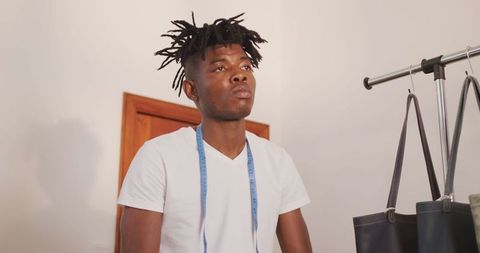 Craftsman organizing leather goods in workshop