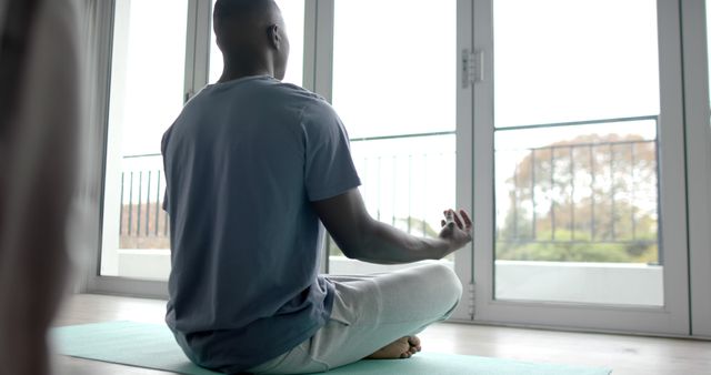 Man Practicing Yoga Meditation at Home Front of Window - Download Free Stock Images Pikwizard.com