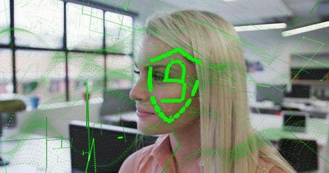 Woman undergoing facial recognition scan with green holographic shield in office