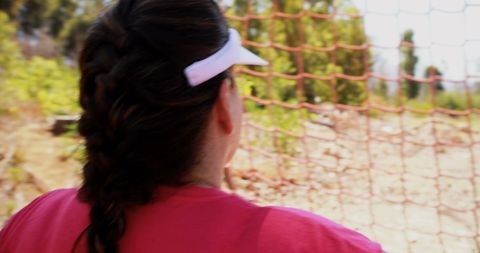 Contemplative Woman Resting After Sports Near Fence