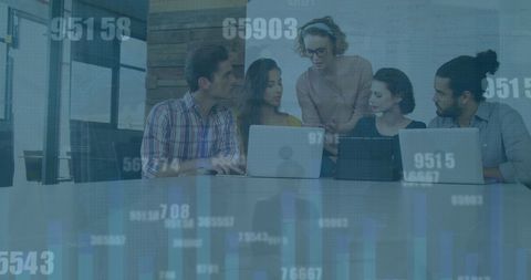 Diverse Team Analyzing Data with Technology in Modern Office