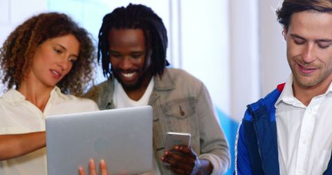 Diverse professionals collaborating with technology in modern workplace