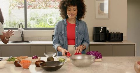 Preparing Fresh Vegetable Salad Together in Bright Modern Kitchen