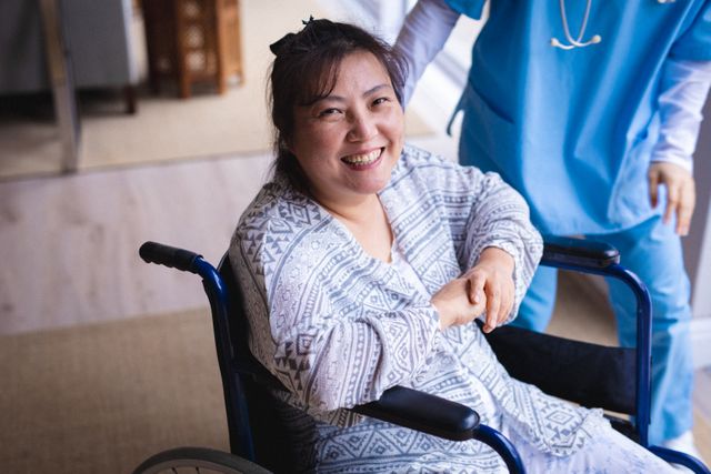 Happy asian senior patient on wheelchair looking at camera. senior healthcare and medical physiotherapy treatment.