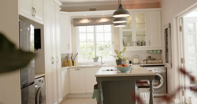 Kitchen island, lamps, furnitures, fringe and windows in sunny kitchen. Interior design, home and domestic life.