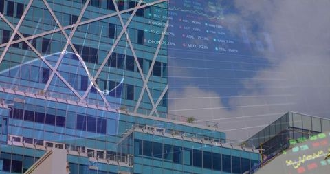 Glass tower showing diagonal steel bracing with financial data overlay over urban rooftops