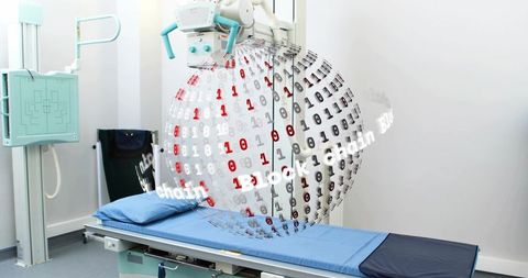 Clinical x-ray room with exam table and binary sphere representing radiology blockchain