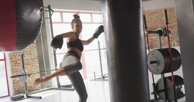 Image of fit caucasian woman boxing and kicking at gym - Download Free Stock Photos Pikwizard.com