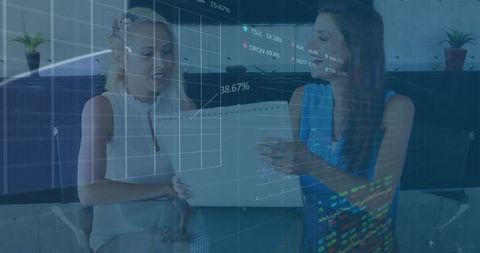 Businesswomen Analyzing Financial Data at Office