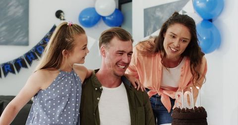 Happy Family Celebrating Father's Birthday with Cake