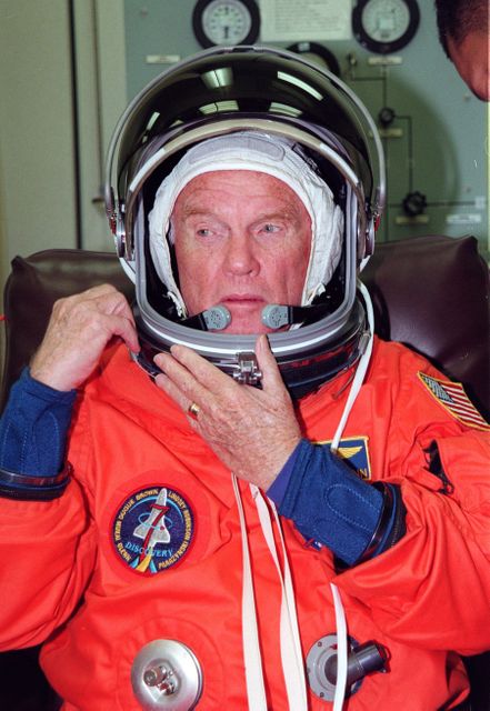 STS-95 Payload Specialist John H. Glenn Jr., a senator from Ohio and one of the original seven Project Mercury astronauts, suits up in the Operations and Checkout (O&C) Building prior to his trip to Launch Pad 39-B. Glenn and the rest of the STS-95 crew are at KSC to participate in the Terminal Countdown Demonstration Test (TCDT) which includes mission familiarization activities, emergency egress training, and a simulated main engine cutoff. The other crew members are Payload Specialist Chiaki Mukai (M.D., Ph.D.), representing the National Space Development Agency of Japan (NASDA), Pilot Steven W. Lindsey, Mission Specialist Scott E. Parazynski, Mission Specialist Stephen K. Robinson, Mission Specialist Pedro Duque of Spain, representing the European Space Agency (ESA), and Mission Commander Curtis L. Brown. The STS-95 mission, targeted for liftoff on Oct. 29, includes research payloads such as the Spartan solar-observing deployable spacecraft, the Hubble Space Telescope Orbital Systems Test Platform, the International Extreme Ultraviolet Hitchhiker, as well as the SPACEHAB single module with experiments on space flight and the aging process. Following the TCDT, the crew will be returning to Houston for final flight preparations