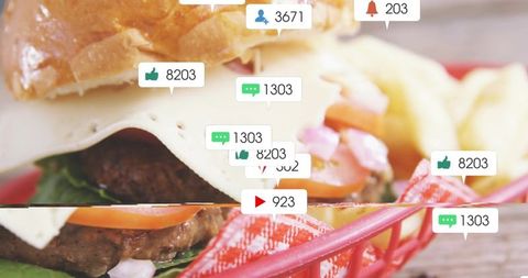 Social notifications floating over cheeseburger with fries in red basket
