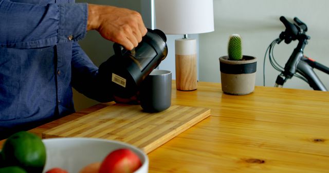 Man Pouring Coffee from French Press on Wooden Counter in Modern Kitchen - Download Free Stock Images Pikwizard.com