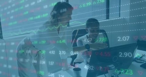 Diverse team analyzing financial data on computer screens