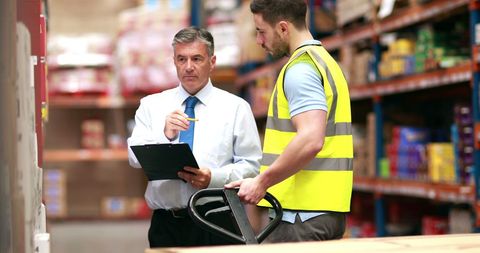 Warehouse Manager Discussing Logistics with Worker - Download Free Stock Images Pikwizard.com