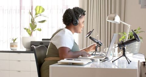 Focused Woman Podcasting from Modern Home Office