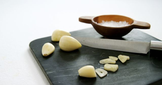 Garlic Cloves and Knife on Cutting Board in Kitchen Preparation - Download Free Stock Images Pikwizard.com