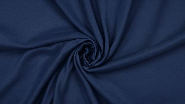 Elegant navy blue fabric swirl with fine weave texture