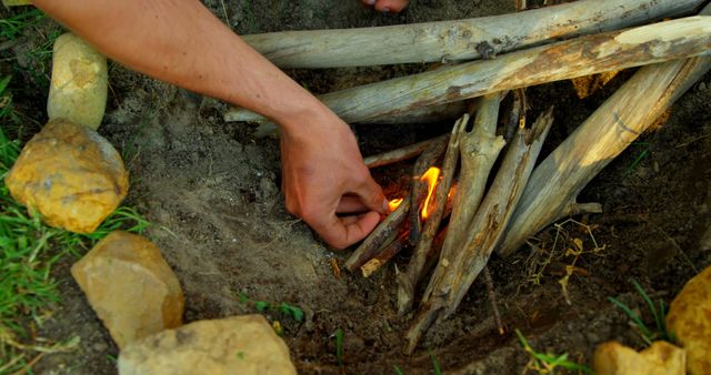 Person Lighting Campfire in Outdoor Setting - Download Free Stock Images Pikwizard.com