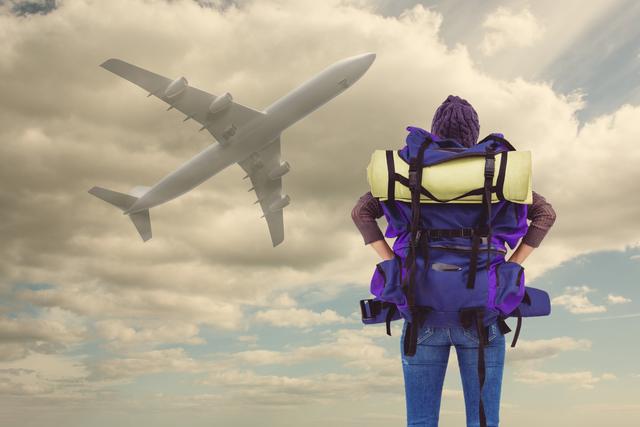 Digital composite of Female traveler with backpack looking at airplane