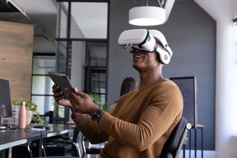 Man embracing virtual reality with vr headset in modern office