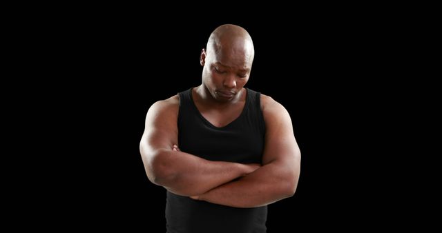 Pensive Man with Crossed Arms in Black Tank Top Against Black Background - Download Free Stock Images Pikwizard.com