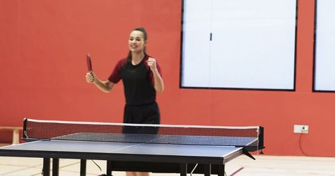 Cheerful female table tennis player celebrating a victory