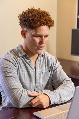Businessman Engaged in Video Conference Call in Modern Office Workspace