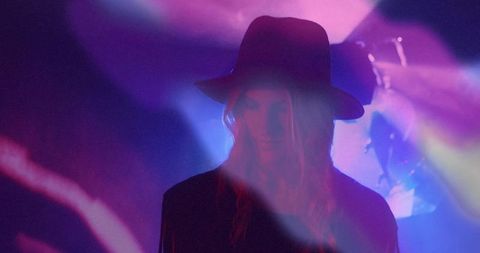 Silhouette of Woman Performing in Nightclub with Vibrant Lights