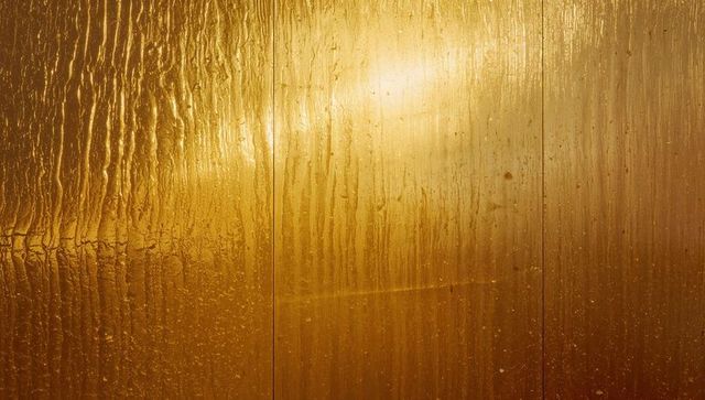 Amber-Tinted Glass Panels with Streaked Water Droplets