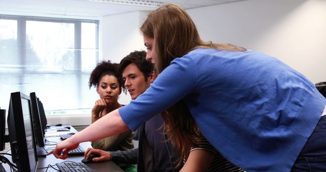 Diverse Students Collaborating on Computer Project in Modern Classroom - Download Free Stock Images Pikwizard.com