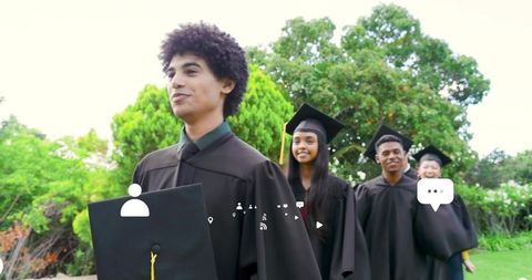 Walking graduates wearing caps and gowns on campus lawn with digital ui overlays